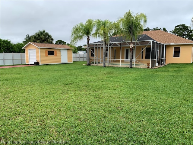 view of yard with a lanai, a storage shed, and a swimming pool