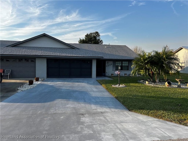 single story home featuring a front yard and a garage