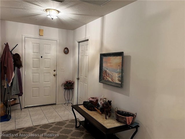 foyer entrance featuring light tile patterned flooring