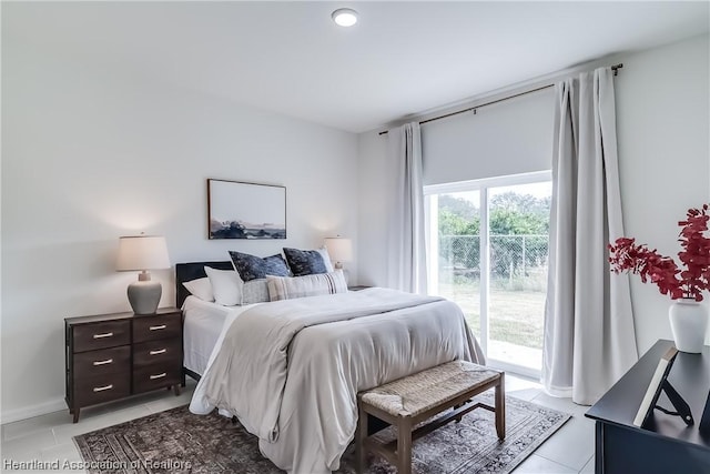 bedroom featuring light tile patterned floors and access to outside