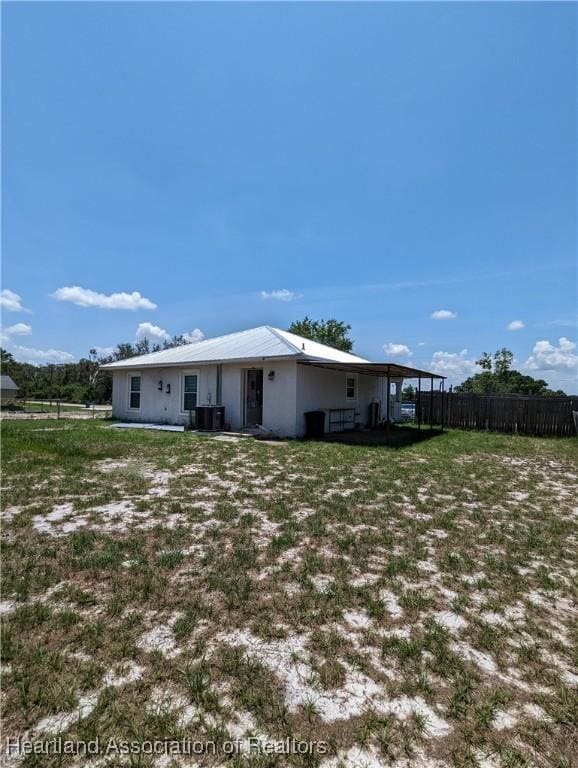 2146 Hartman Rd, Avon Park, FL 33825 - rear view of house with cooling unit and stucco siding