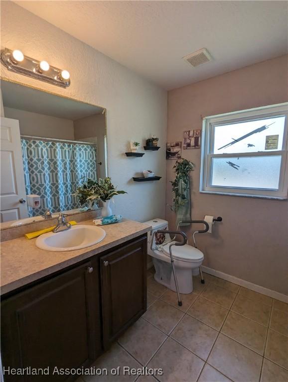 2146 Hartman Rd, Avon Park, FL 33825 - bathroom featuring vanity, tile patterned flooring, and toilet