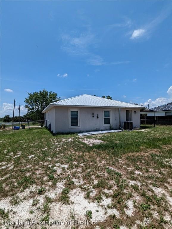 2146 Hartman Rd, Avon Park, FL 33825 - back of house featuring stucco siding and central AC unit
