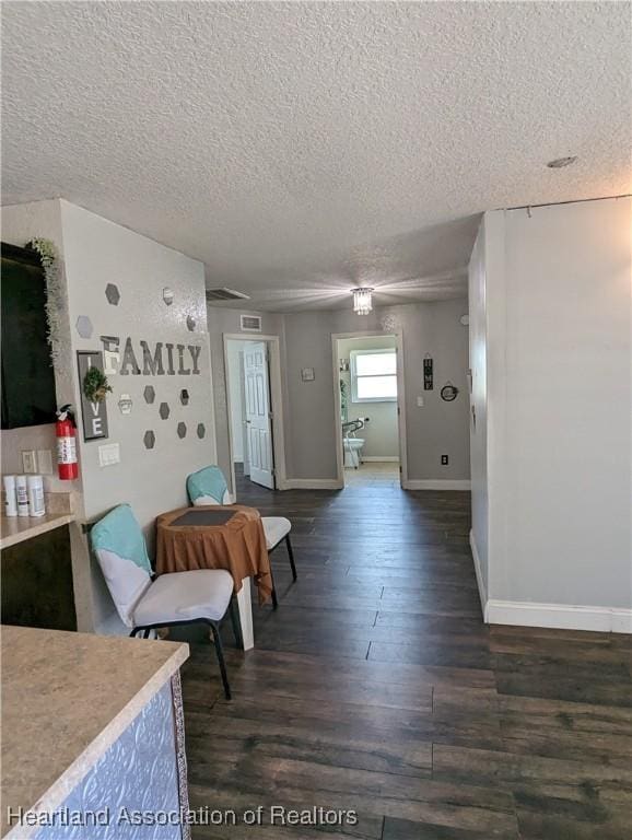 2146 Hartman Rd, Avon Park, FL 33825 - interior space with a textured ceiling, dark wood-style floors, and baseboards