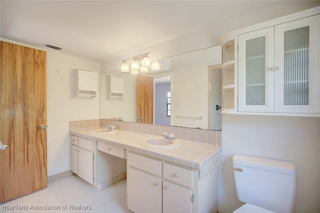 bathroom with tile patterned floors, toilet, and vanity