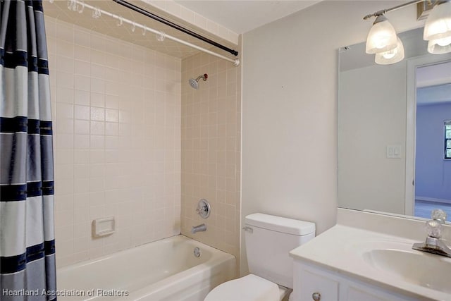 full bathroom with toilet, vanity, and shower / tub combo with curtain