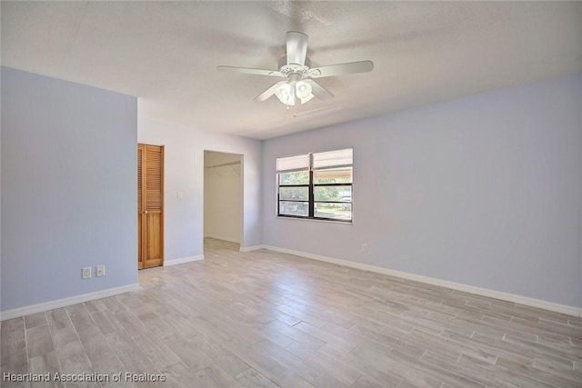 spare room featuring ceiling fan and light hardwood / wood-style floors