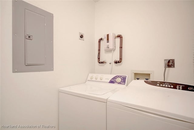 clothes washing area with washer and dryer and electric panel