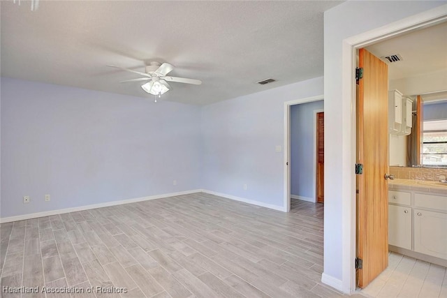 spare room featuring light hardwood / wood-style flooring and ceiling fan