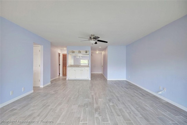 unfurnished living room featuring ceiling fan and light hardwood / wood-style floors