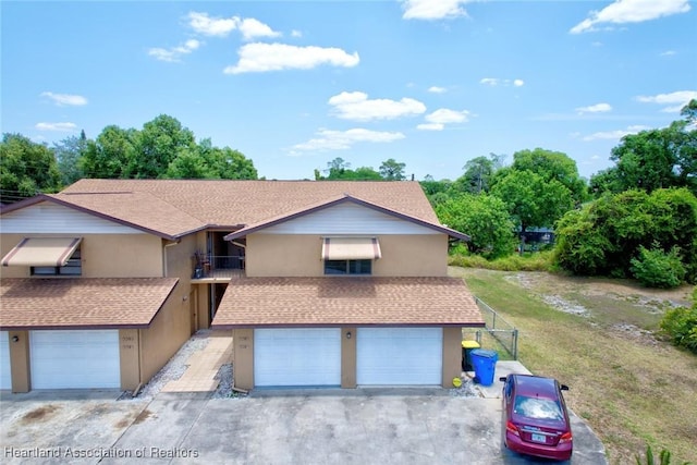 view of front of home featuring a balcony and a garage