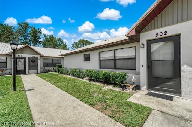 entrance to property with a yard