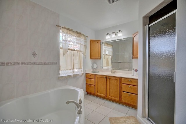 bathroom with tile patterned floors, shower with separate bathtub, and vanity