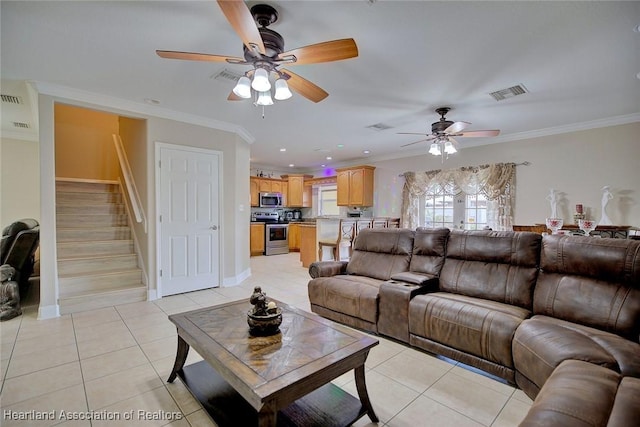 living room with light tile patterned floors, crown molding, and ceiling fan