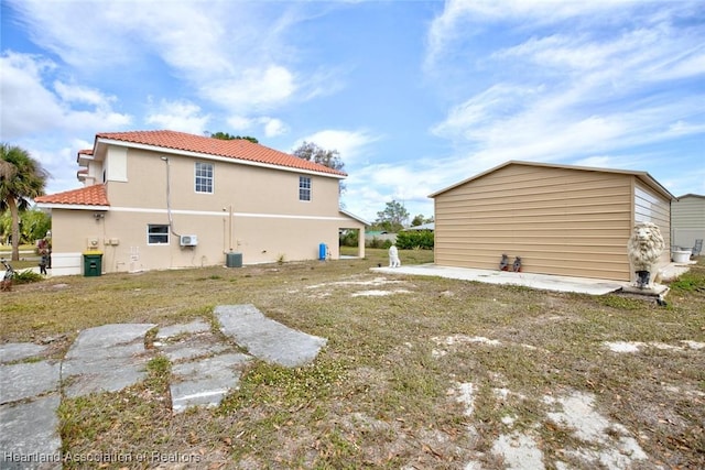 rear view of house with a patio and cooling unit