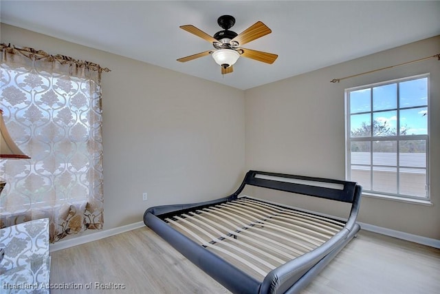 unfurnished bedroom with ceiling fan and wood-type flooring