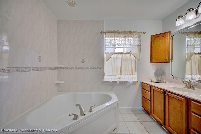 bathroom with tile patterned flooring, vanity, a healthy amount of sunlight, and a bathtub