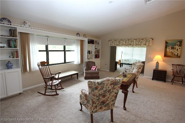 sitting room featuring light carpet and vaulted ceiling