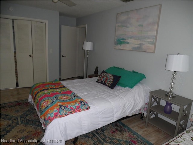 bedroom featuring wood finished floors and a closet