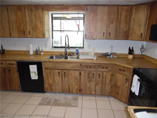 1605 Lake Clay Dr, Lake Placid, FL 33852 - kitchen with black appliances, a sink, brown cabinets, and light countertops