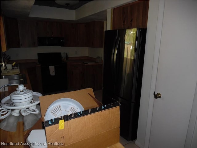 kitchen featuring black appliances and a sink
