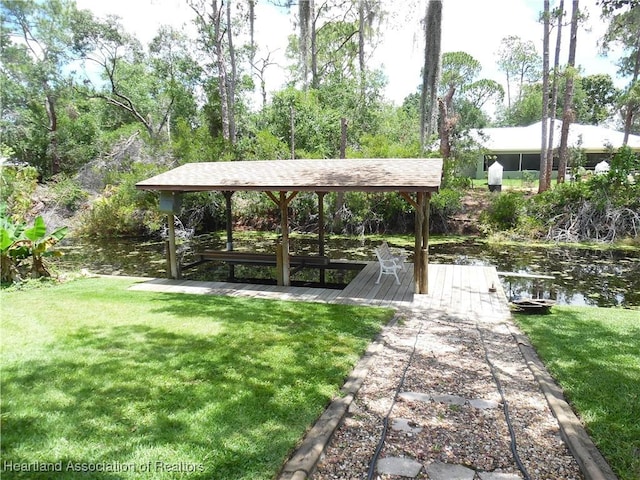 1605 Lake Clay Dr, Lake Placid, FL 33852 - view of community featuring a boat dock, a yard, and a water view