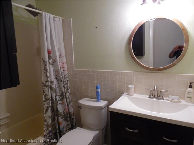1605 Lake Clay Dr, Lake Placid, FL 33852 - full bathroom with toilet, vanity, a wainscoted wall, tile walls, and shower / bath combination with curtain