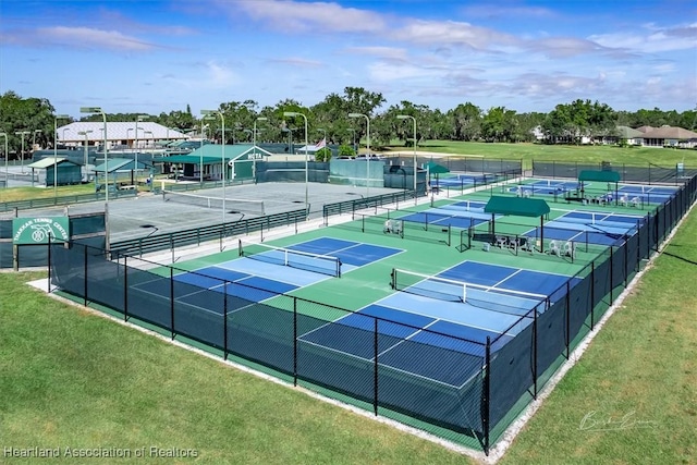 view of sport court with a yard