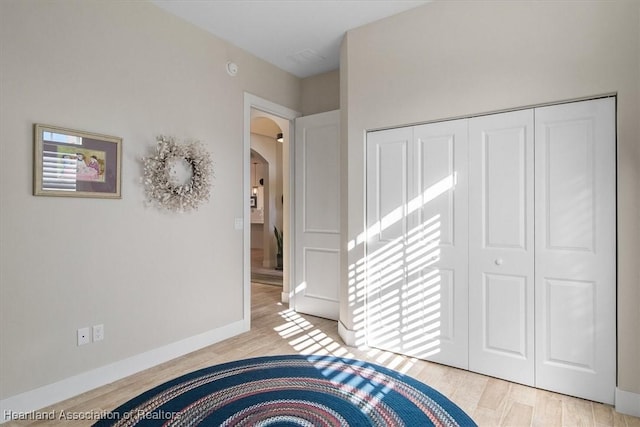 bedroom featuring a closet and light wood-type flooring