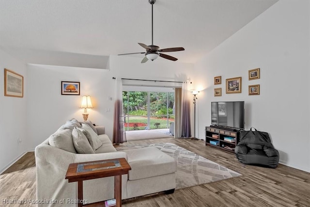 living room featuring ceiling fan, lofted ceiling, and hardwood / wood-style floors