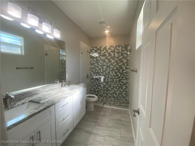 bathroom with vanity, an enclosed shower, and toilet