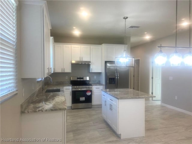 kitchen featuring pendant lighting, white cabinetry, a center island, and stainless steel appliances