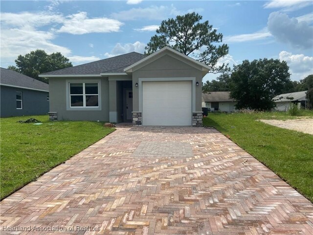 view of front of property featuring a garage and a front lawn