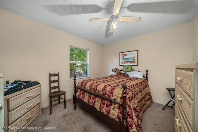 bedroom featuring light carpet, ceiling fan, and a textured ceiling