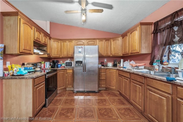 kitchen featuring lofted ceiling, ceiling fan, stainless steel appliances, a sink, and exhaust hood