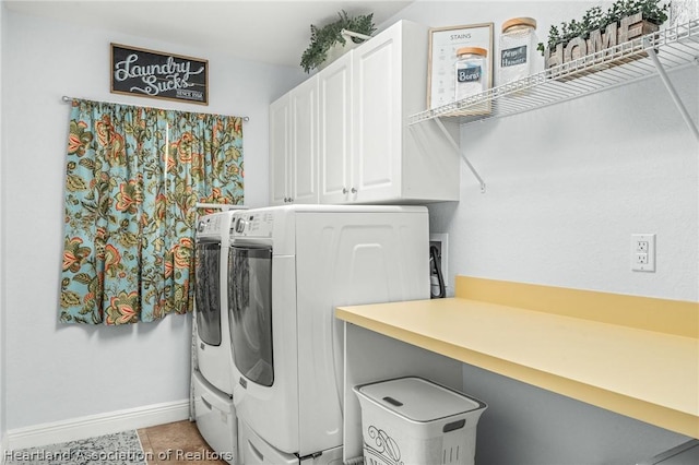 laundry room with tile patterned floors, washer and dryer, and cabinets