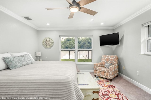 carpeted bedroom featuring ceiling fan and ornamental molding