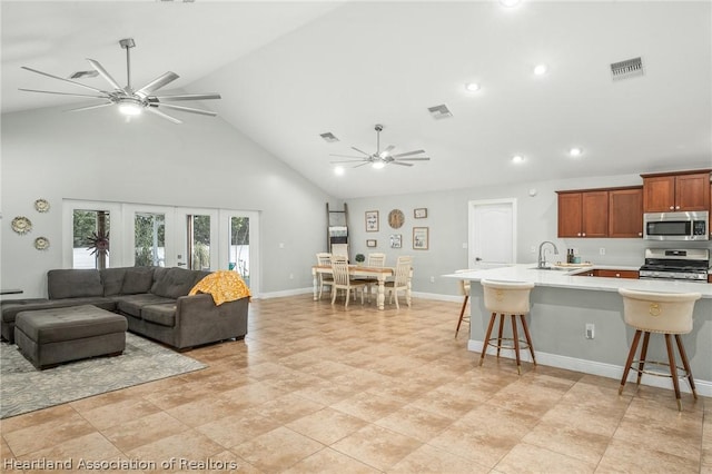 living room with sink and high vaulted ceiling