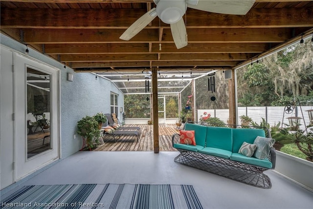 sunroom / solarium with a wealth of natural light and ceiling fan