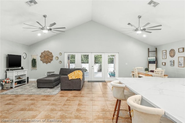 living room featuring french doors, high vaulted ceiling, and light tile patterned flooring