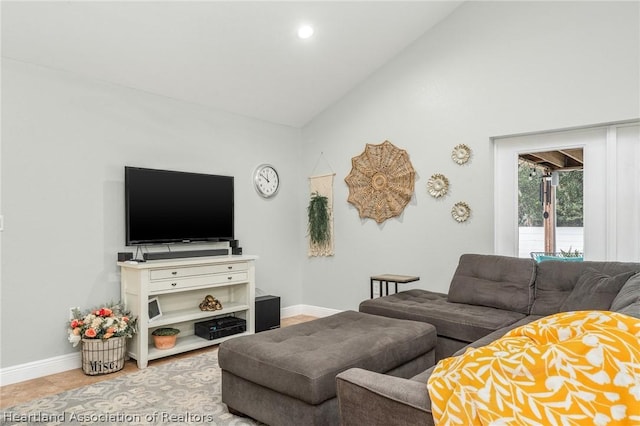 tiled living room featuring high vaulted ceiling