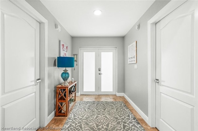 foyer with french doors and light tile patterned floors