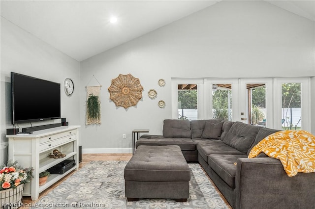 living room with french doors and lofted ceiling