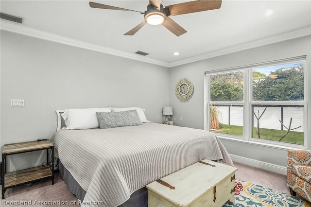 carpeted bedroom with ceiling fan and crown molding