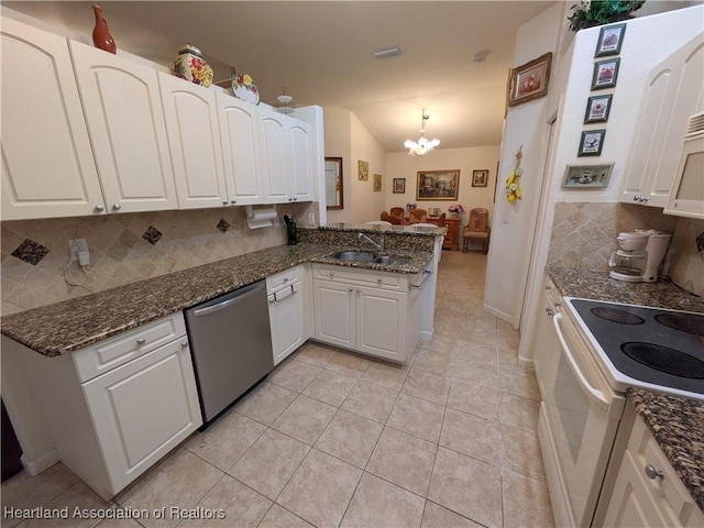 kitchen featuring kitchen peninsula, white appliances, and white cabinets