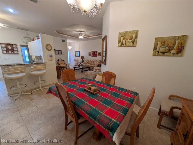 dining room with ceiling fan with notable chandelier