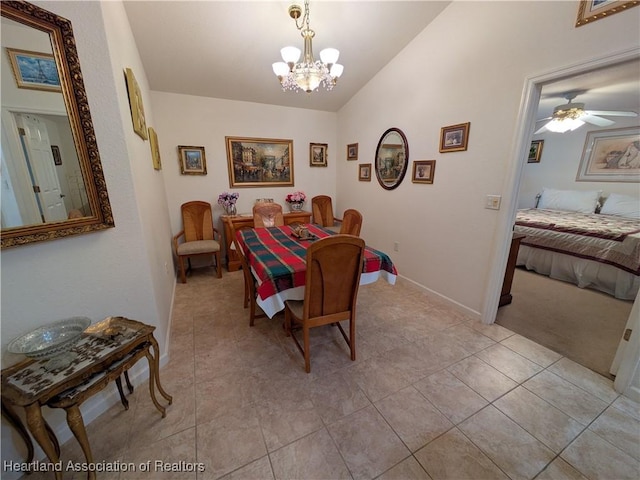 tiled dining room with ceiling fan with notable chandelier and vaulted ceiling