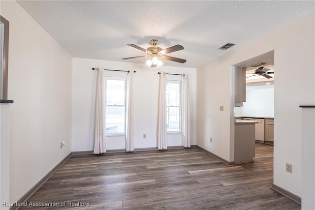 1811 Jackson Dr, Sebring, FL 33870 - spare room featuring a textured ceiling, dark wood-style floors, ceiling fan, and visible vents