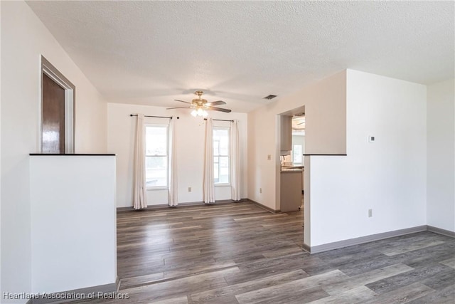 1811 Jackson Dr, Sebring, FL 33870 - unfurnished room with baseboards, a textured ceiling, wood finished floors, and a ceiling fan