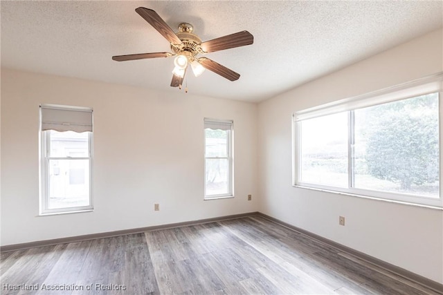 1811 Jackson Dr, Sebring, FL 33870 - spare room featuring baseboards, wood finished floors, and a textured ceiling